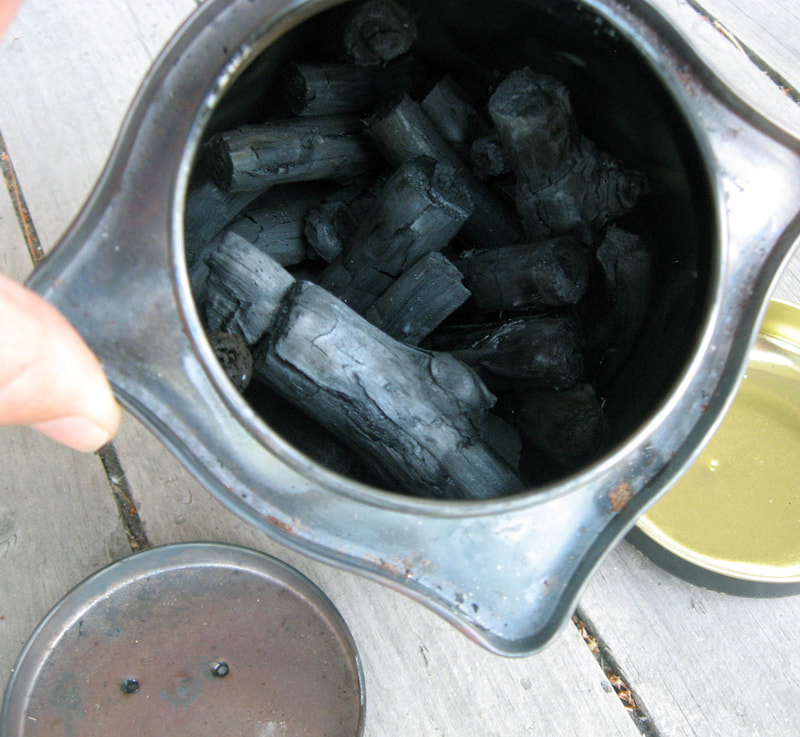 Kiln (or tea tin) of charcoal opened the morning after firing.